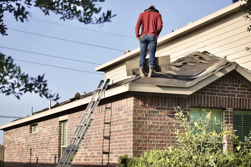 Professional roofer working on a residential roof in Mitchellville